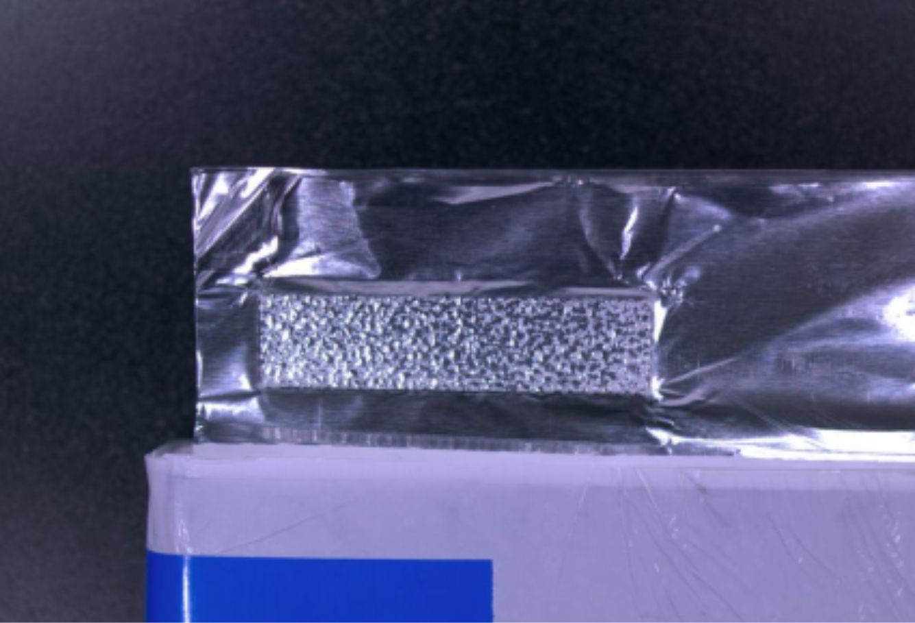 Electrode tab pre-weld surface: the high reflectivity and irregular foil geometry defeat conventional single-source machine vision.
