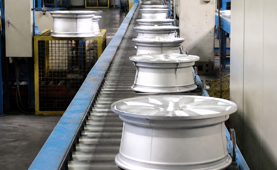 Aerospace wheel components on a production conveyor